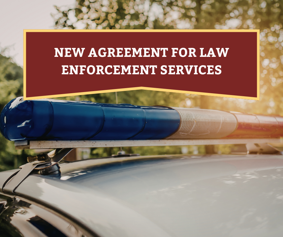 Police light bar with text reading New Agreement for Law Enforcement Services
